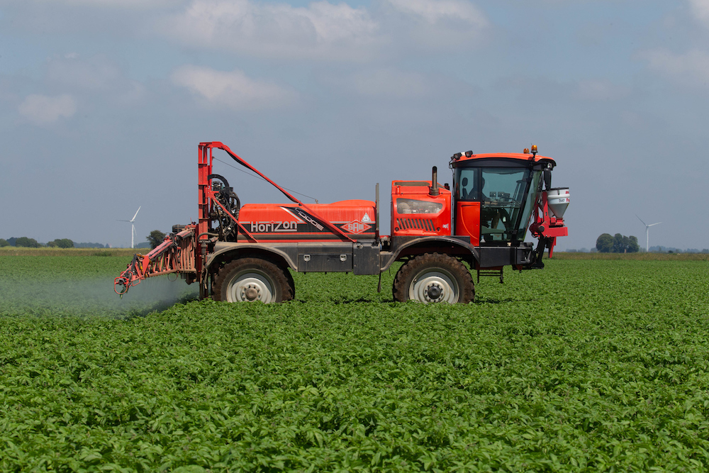 Spraying potatoes for blight (Credit Tim Scrivener for use with Zorvec